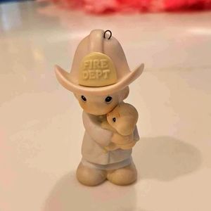Precious moments fireman ornament.